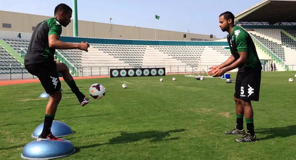 Talent Scouting in Sports Evolving Talent Scouting. "A modern talent scouting setup showcasing AI-powered tools in action. The image includes a mobile device displaying real-time athlete performance metrics, a scout analyzing data, and a player demonstrating skills on the field, symbolizing the integration of technology in sports talent identification."