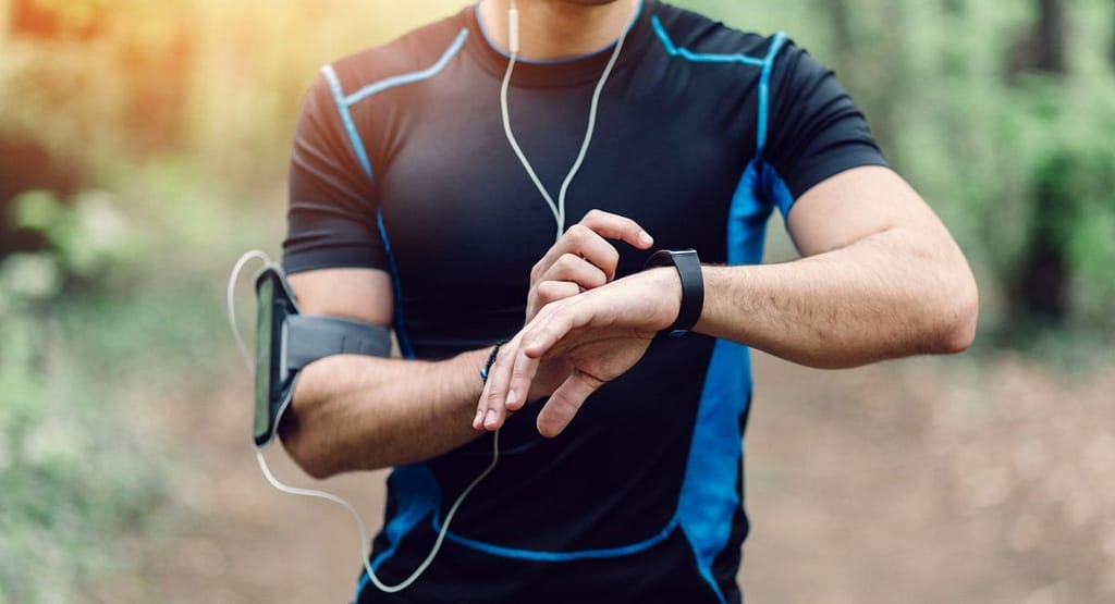 AI-Driven Muscle Recovery Wearables An athlete wearing a sleek, lightweight AI-driven muscle recovery wearable, showcasing its ability to deliver personalized therapies like EMS and heat therapy during post-workout recovery.