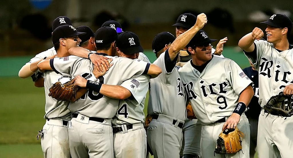 A baseball player mid-pitch on the mound, wearing a black baseball cap paired with a blue and black jersey, white pants, and cleats. The cap complements the player's athletic look while providing functional sun protection, highlighting its dual role as a style and performance essential for 2025. Men’s Black Baseball Cap: The Ultimate Style and Performance Essential for 2025