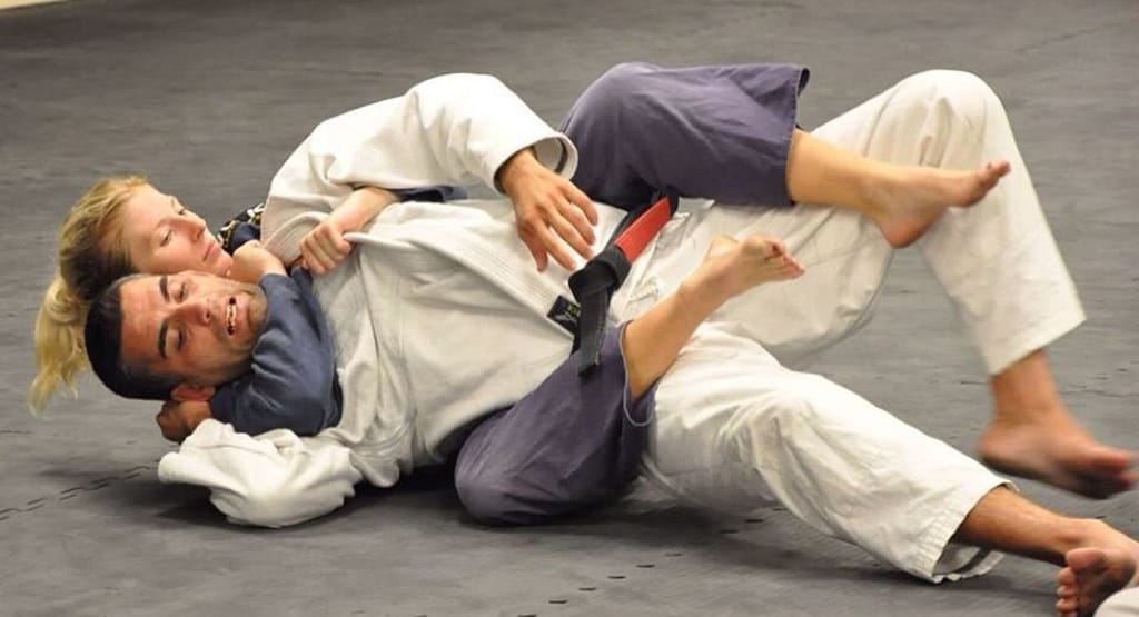 Keanu Reeves executing a Brazilian Jiu-Jitsu armbar in John Wick, a prime example featured in Movies About Brazilian Jiu-Jitsu: The Gentle Art on Screen