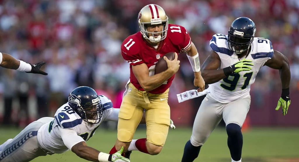 "Four male rugby players wearing professional rugby uniforms, including Akuma high-performance rugby shorts, standing confidently in a studio setting. The players are dressed in matching blue and red kits branded with 'RaboDirect' and 'BLK,' showcasing athletic fit, modern design, and functional sportswear tailored for competitive performance."