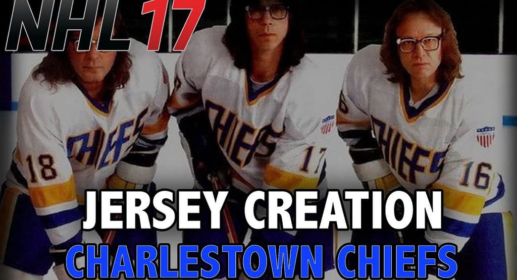 Action shot from a professional ice hockey game showing players in motion. While the image features teams in black and white/red jerseys, it does not depict the classic Chiefs hockey jersey made famous by the fictional Charlestown Chiefs from Slap Shot. The Chiefs jersey typically features blue and gold striping with bold "Chiefs" lettering across the chest