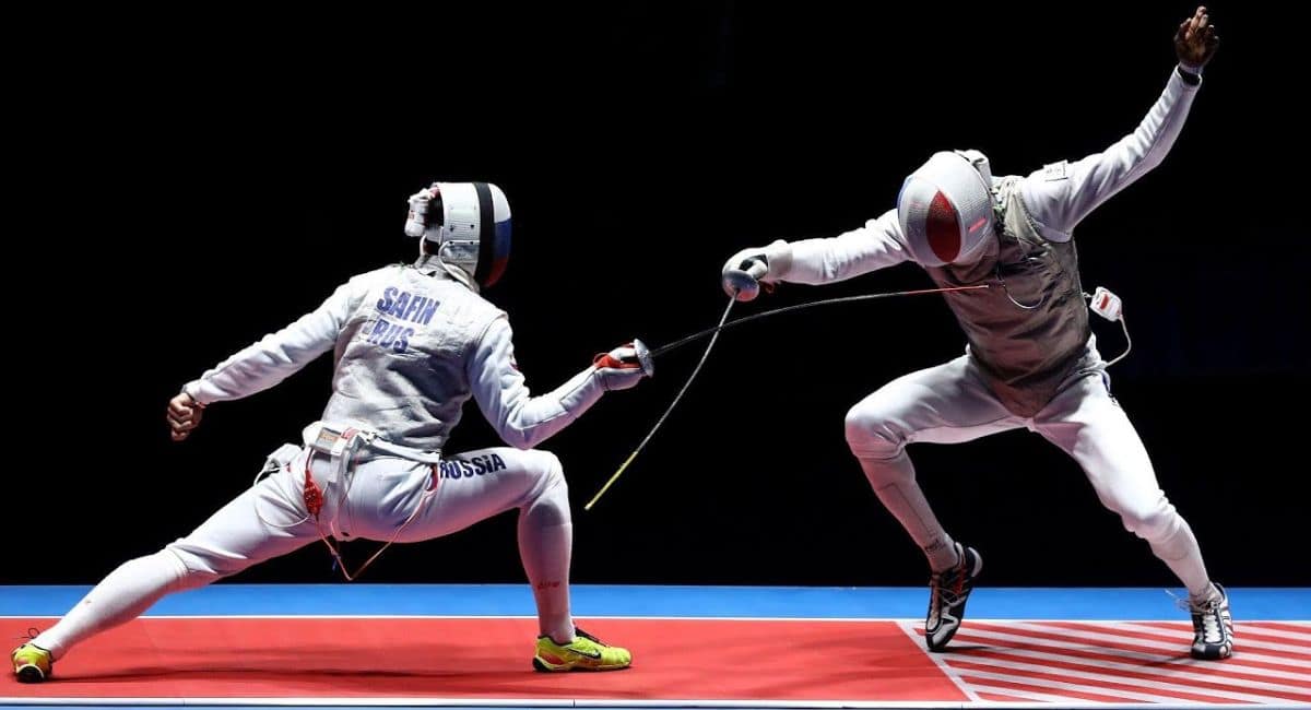 "Two fencers in mid-action during a high-speed bout, each demonstrating precise timing and explosive movement. One fencer lunges forward while the other parries with agile footwork and blade control showcasing the critical role of tempo and timing in competitive fencing."